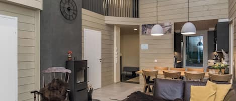A spacious living area with a fireplace, seating, and a dining area.