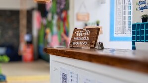 A reception desk with a sign indicating the Wi-Fi password.