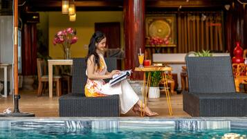 Een buitenzwembad, parasols voor strand/zwembad