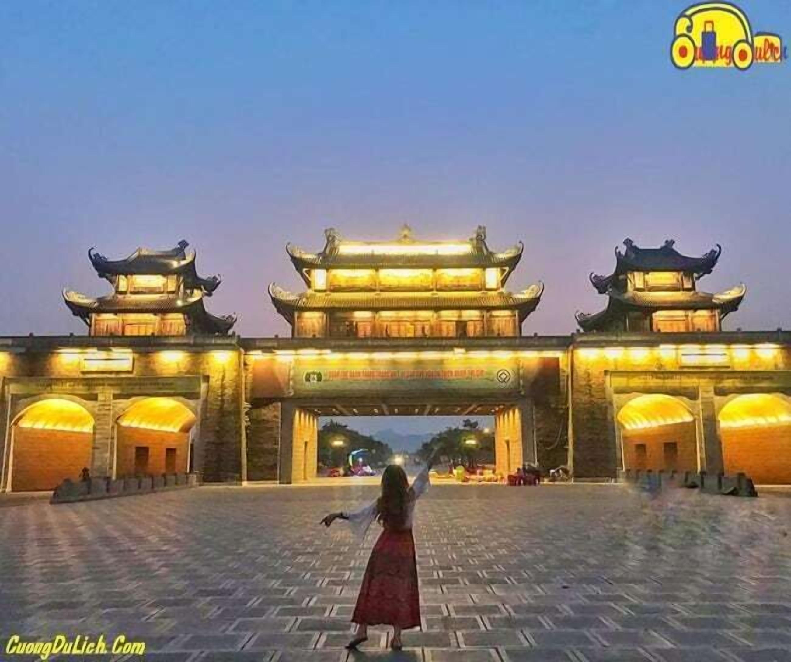 A traditional gate with two towers and a central archway, surrounded by a paved area.