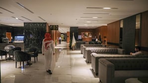 A hotel lobby with a marble floor, sofas, and a reception desk. - E hotel (Madinah)