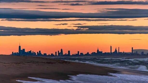 A beach with a city skyline silhouette at sunset. - Sea Bright Beach House Sleeps 6 Perfect for a Family with little ones! (Sea Bright)