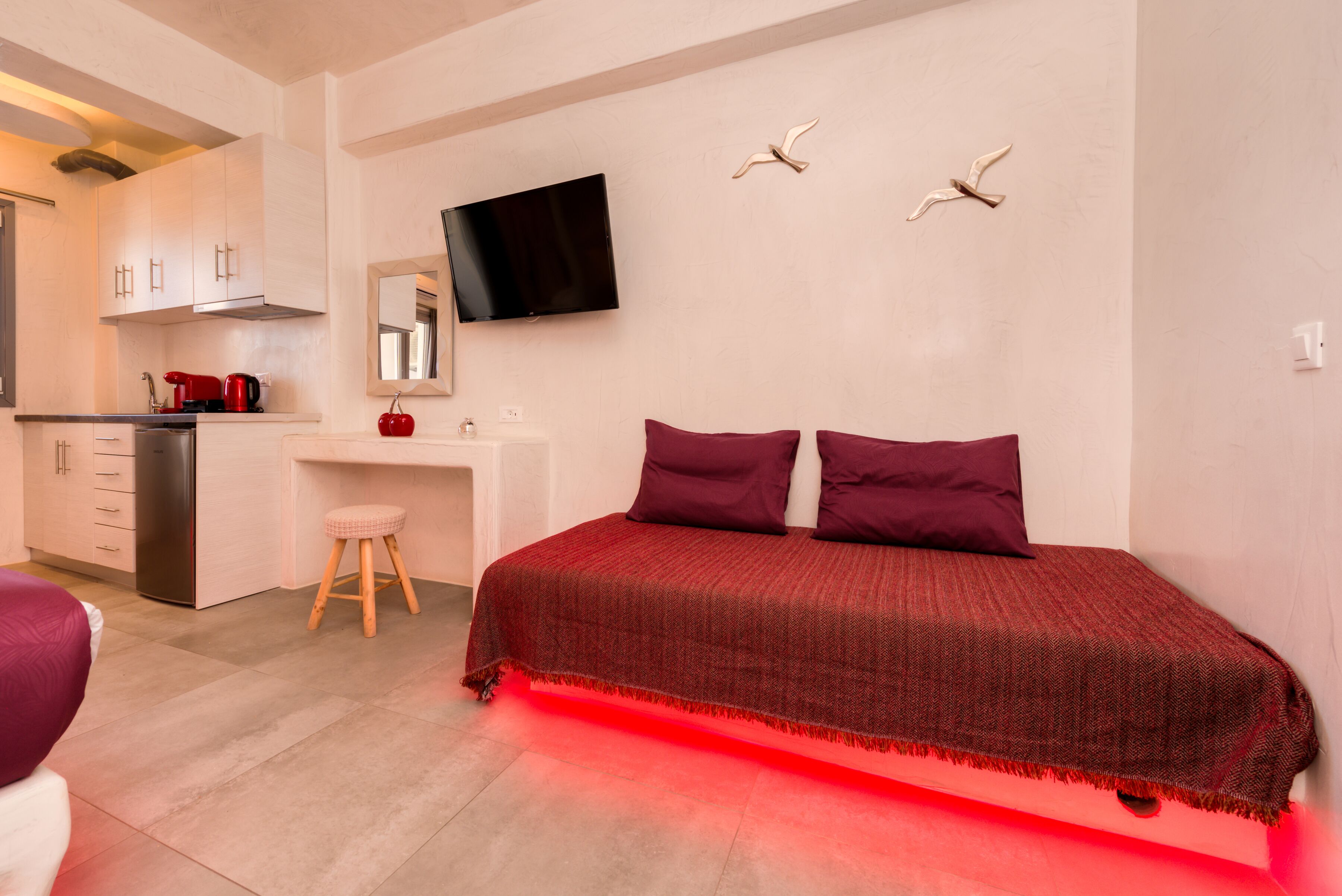 Ein Schlafzimmer mit einem Bett, einem Schreibtisch und einem Fernseher.