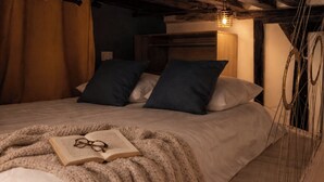 A cozy bedroom with a bed, pillows, a blanket, and a book. - A 2 pas du Panthéon en Plein Cœur du Quartier Latin (Paris)