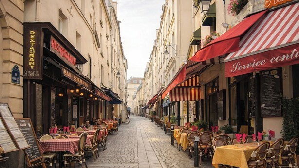 A cobblestone street lined with outdoor dining tables and chairs, restaurant signs, and a narrow street view. - A 2 pas du Panthéon en Plein Cœur du Quartier Latin (Paris)