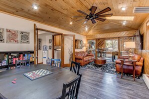 A spacious living area with a wooden ceiling, a coffee station, a chessboard, and leather sofas. - Morrison Retreat ~ 15 Min To Red Rocks Amphitheatre ~ Hot Tub, Game Room, Views (Morrison)