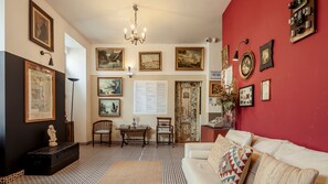 Relax in a cozy living room with a comfortable sofa, vintage cabinet, and elegant decor.
