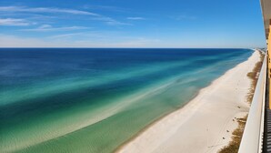 A beach view with clear turquoise waters and a sandy shoreline. - Splash Resort 1403E 🏖 Beachfront Luxury & Free Chairs ✨️ Mega Vacations PCB (Panama City Beach)