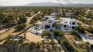 A modern resort with a pool, multiple buildings, and a mountainous backdrop. - 3-bedroom  w/ amazing views, waterfront access, resort amenities & hot/cold tub (El Sargento, La Ventana)