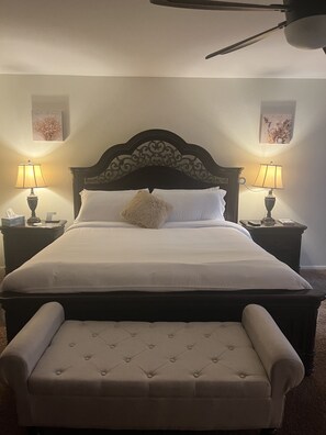 Restful retreat with a large bed, white linens, and bedside lamps.