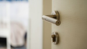 A door with a modern lock and a keyhole. - Vulcania Rooms (Naples)