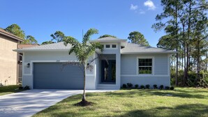 A single-story house with a garage, a small front yard, and a tree. - New beautiful Pool .  May thru Dec 2025 $2599 a month.  $87a night. Contact Pam  (Rotonda West)