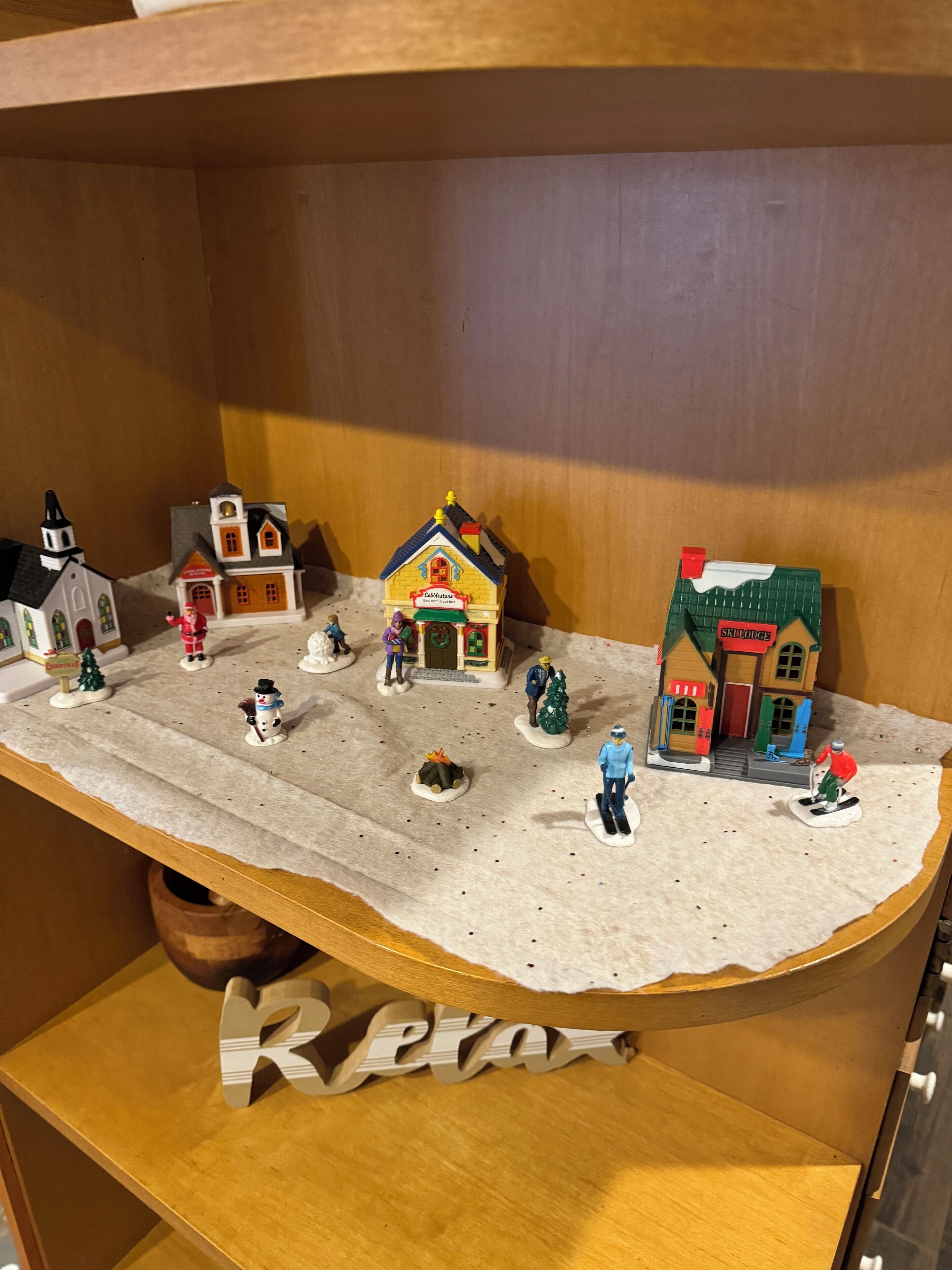 A model of a small town with various buildings, including a church, a bakery, and a shop.