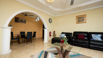 Deluxe Apartment | Living area | 70-inch Smart TV with cable channels