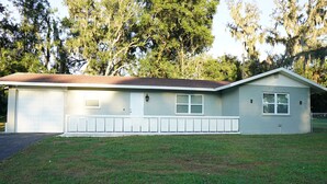 A single-story house with a garage, a small porch, and a front yard. - Spacious Home with Luxury Finish (Brandon)
