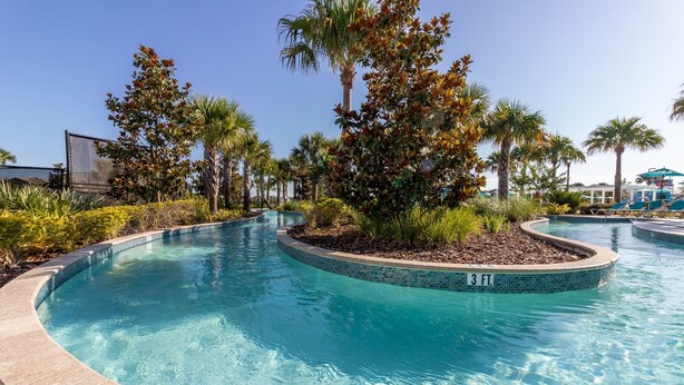 A clear blue pool with a 3 ft. depth marker, surrounded by palm trees and other tropical plants. - Disney Emerald in Windsor Westside-Stunning 5 bed villa close to all attractions (Four Corners)
