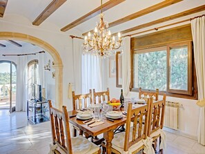 Enjoy a warm and inviting dining experience in this elegantly designed room, complete with a dining table for four and a beautiful view.