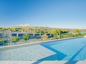 Relax by the pool surrounded by lush greenery and breathtaking mountain views.