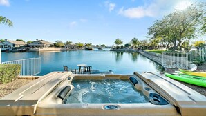 A hot tub by a calm water body with a clear sky. - Lakefront Oasis (Glendale)