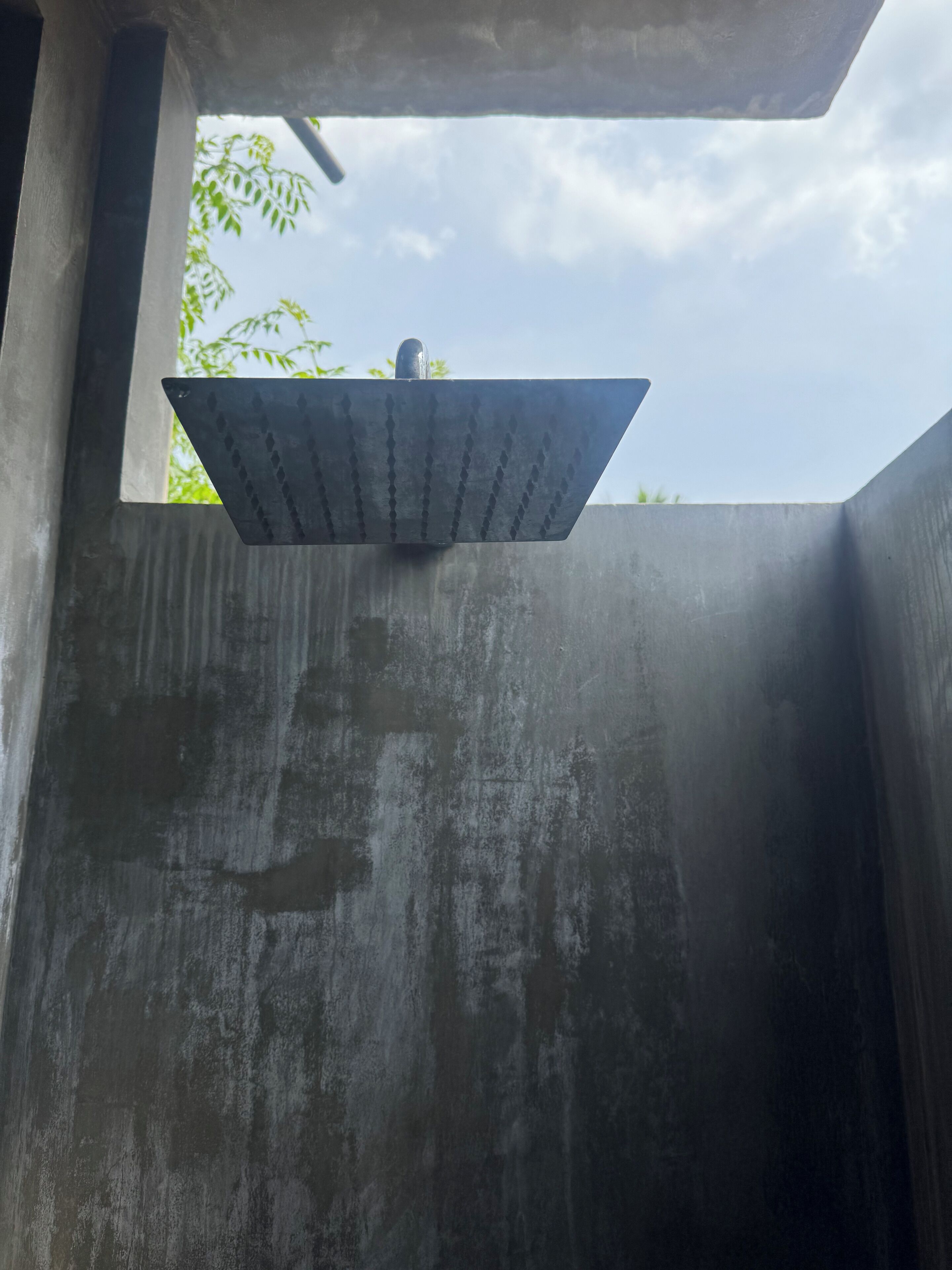 A modern shower enclosure with a rectangular design and a visible drain.