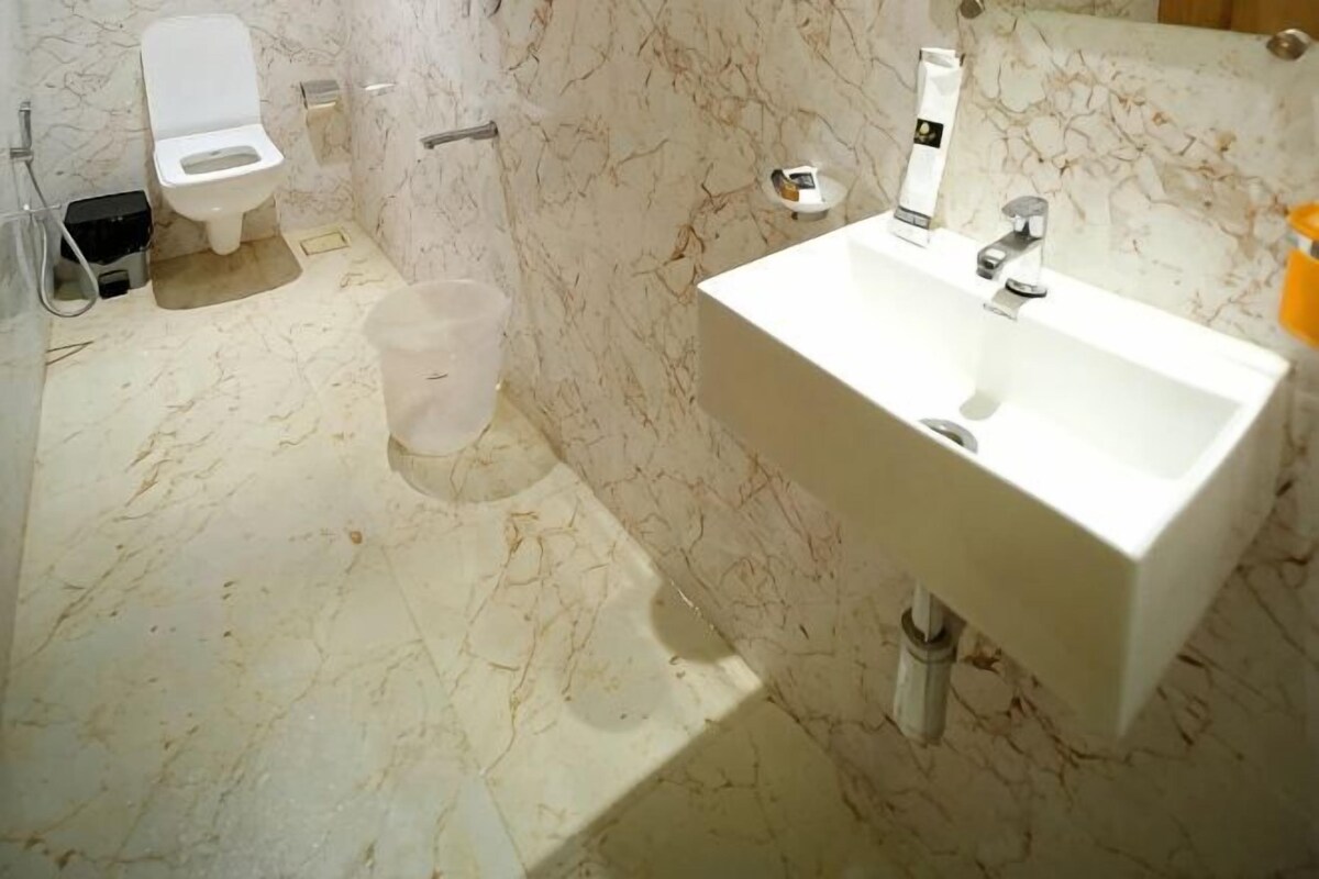A bathroom with a toilet, sink, and shower.