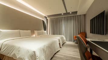 A modern hotel room with a large bed, two bedside tables, a desk, and a chair.