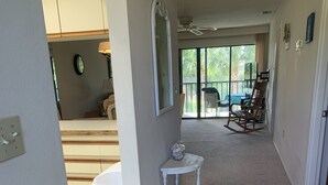 A hallway with a white table, a mirror, and a ceiling fan. - Near Beaches! UPDATED! Peaceful Forest Park Condo 2 bd 2 bth. Heat comm pool (Englewood)