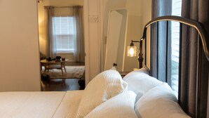 A neatly made bed with white linens in a hotel room. - 1-Bedroom Maltby Home: Perfect for Work & Leisure, Close to Wine Country (Snohomish)