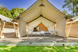 A tented accommodation with a wooden deck, two beds, and a chair. - Grow Tree Glamping (Dahu)