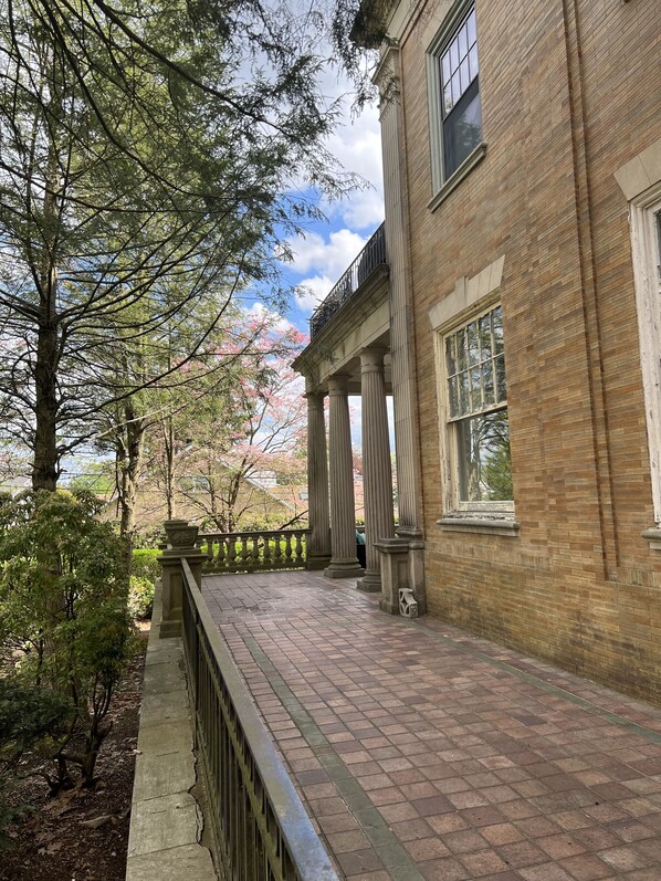 A brick building with classical columns and a balcony. - The Dery House  (Catasauqua)