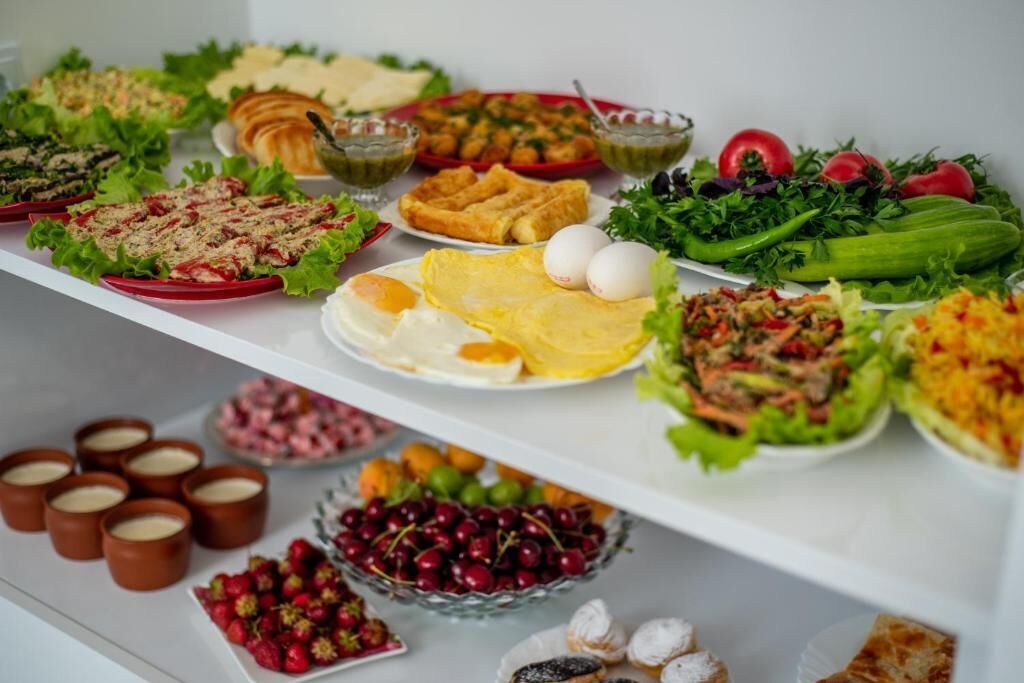 A buffet with various dishes including salads, eggs, and desserts.