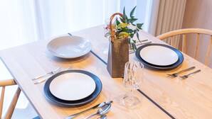 A dining table set with plates, cutlery, and a glass. - Stagione Hakone Yumoto Villa (Hakone)
