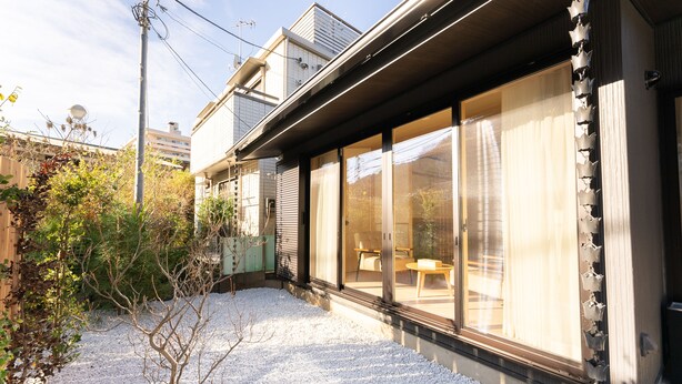 A modern house with large sliding glass doors, a gravel driveway, and a small garden area. - Stagione Hakone Yumoto Villa (Hakone)