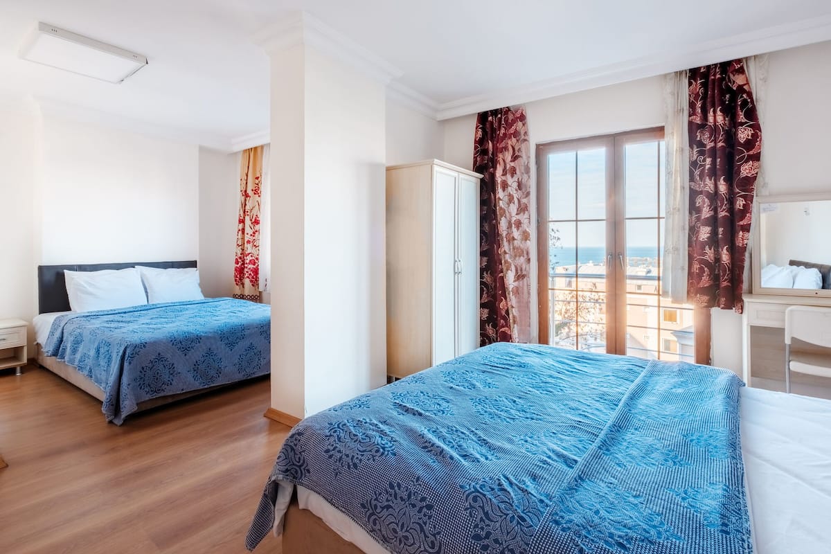 Habitación cuádruple familiar, vistas al mar | Escritorio y ropa de cama