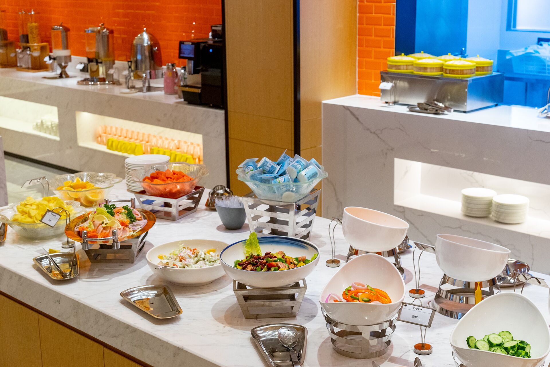 A buffet with various food items and condiments.