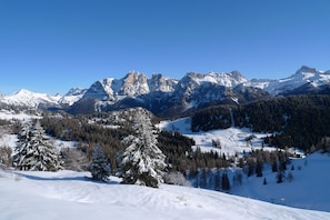 A snow-covered mountain landscape with clear skies.