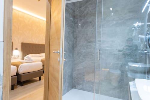 Economy Quadruple Room, 2 Bathrooms | Bathroom | Shower, free toiletries, hair dryer, slippers