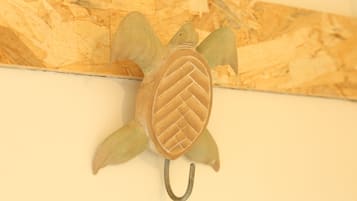 A turtle-shaped wall decoration with a textured shell and a hook.