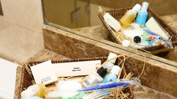 A bathroom with a marble countertop and a mirror reflecting a wicker basket containing toiletries.