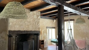 A rustic room with exposed wooden beams, a stone fireplace, and a hanging hammock. - Dordogne, Maison Avec Grande Piscine, 5 Chambres, 11 Couchages + 2 Lits Bébé (Agonac)