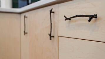 A wooden cabinet with black handles.