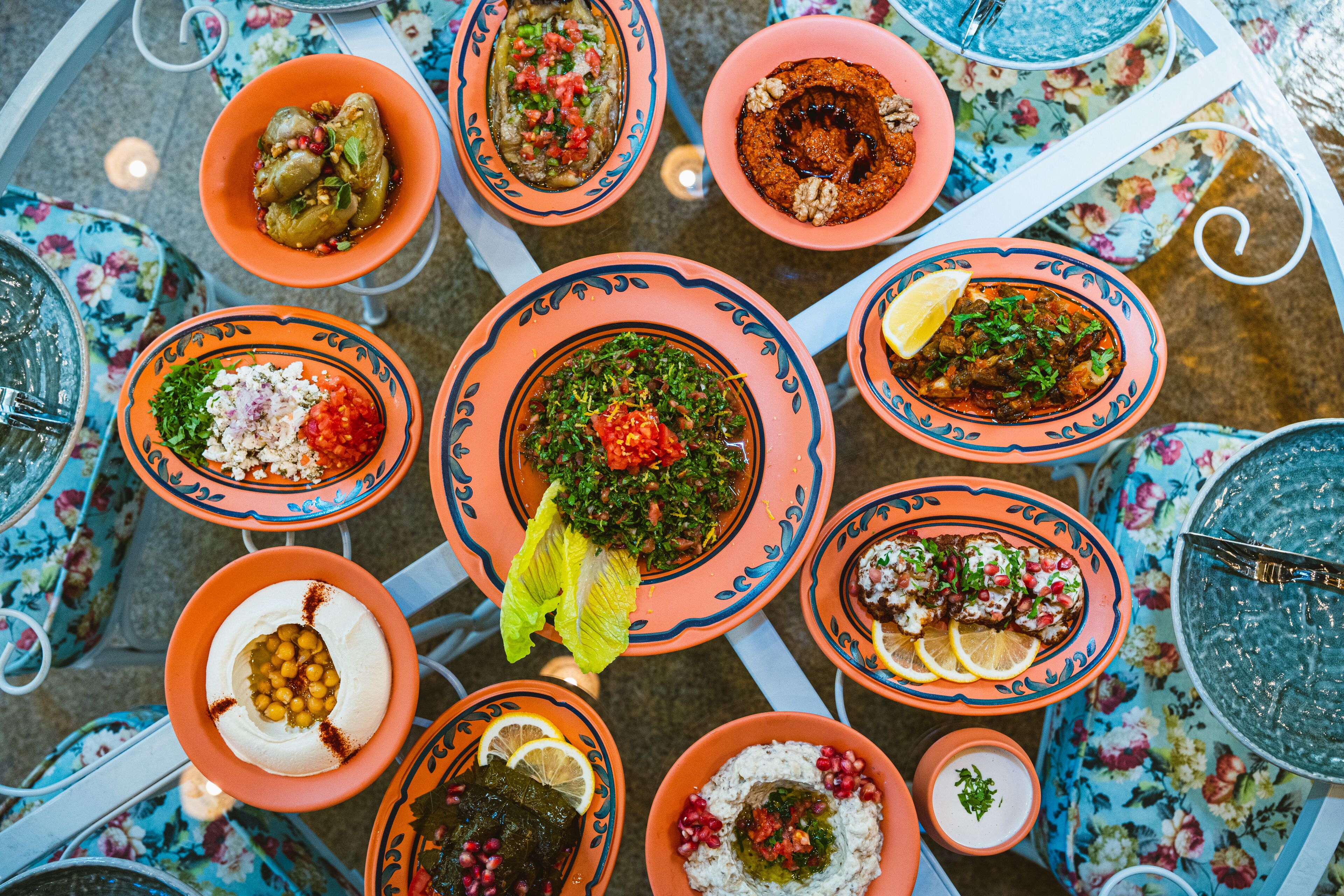 A top-down view of a dining table with various dishes and a bowl of ice.