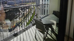 A balcony with a view of a cityscape, including buildings and a road. - Belgrade Waterfront Tower View (Belgrade)