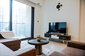 Deluxe Apartment | Living area | 55-inch Smart TV with cable channels - SuperHost - Downtown Gem: 1BR Apartment at Act One l Act Two (Dubai)