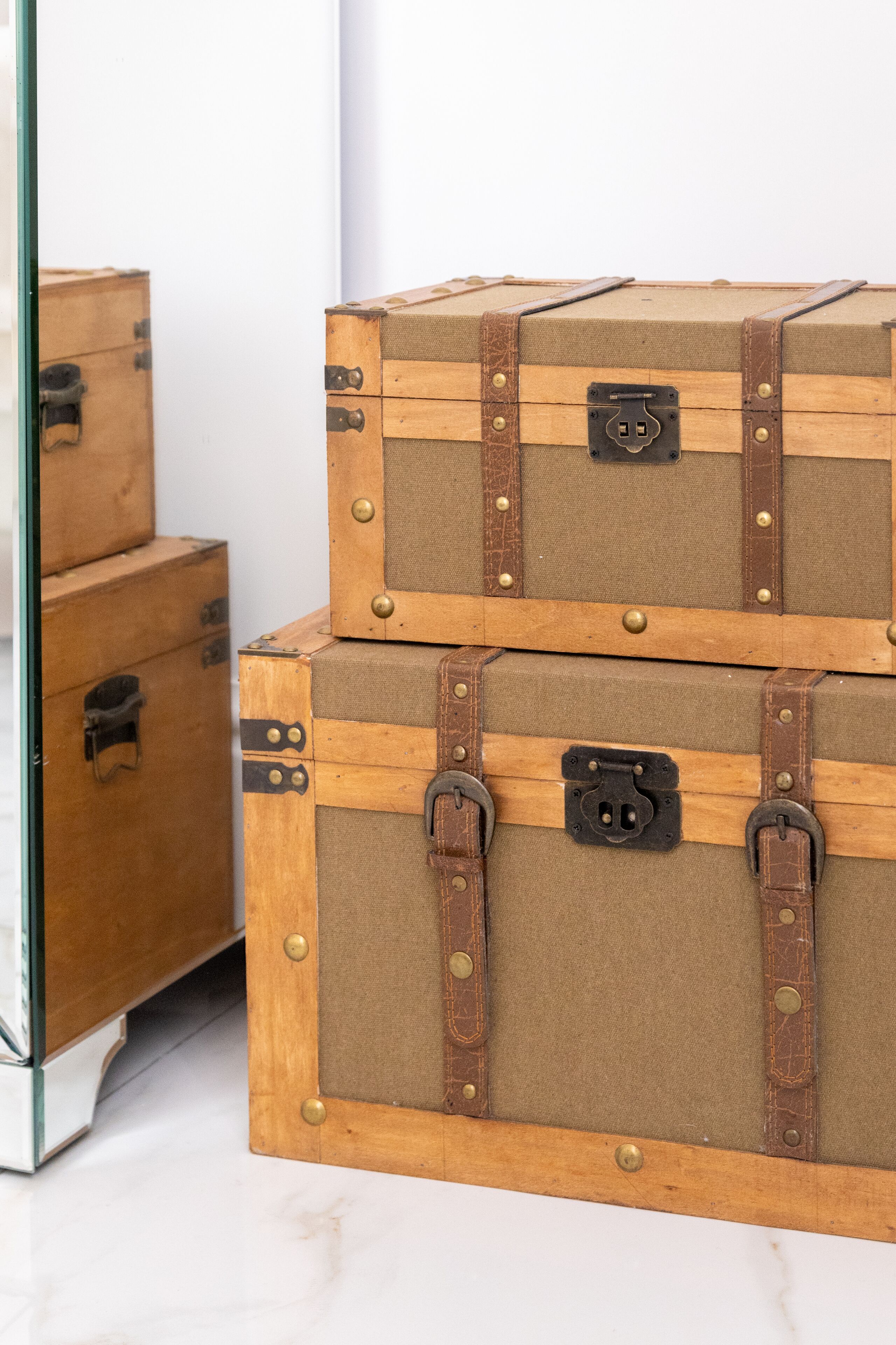 Two stacked wooden trunks with metal clasps and a lock.