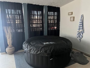 Cozy retreat with a circular bed and large window.