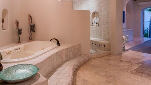 A modern bathroom with a freestanding bathtub, a glass bowl sink, and decorative wall art. - Luxurious Villas Del Mar Casita 6 with Sweeping View! (Los Cabos)