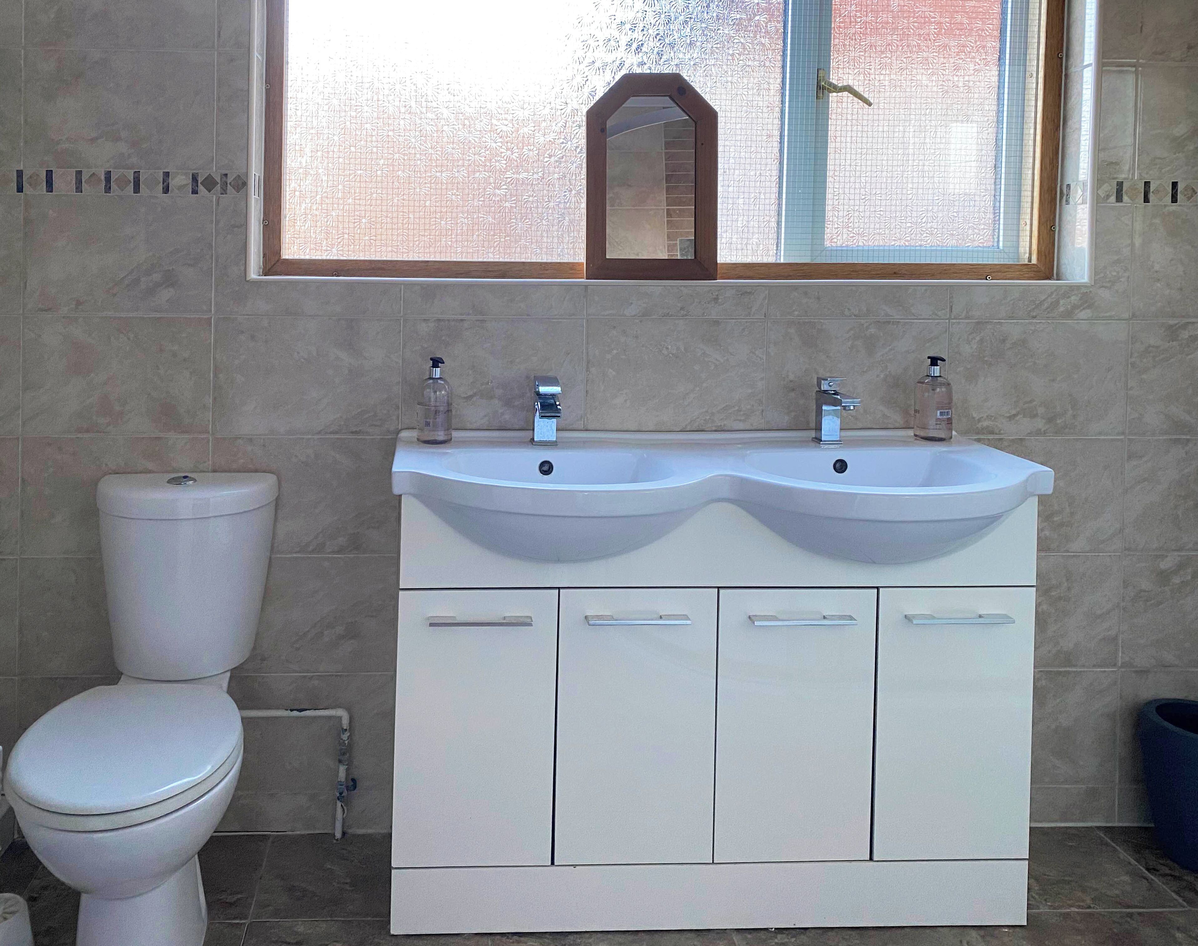Basic Suite | Bathroom | Shower, hair dryer, towels, toilet paper