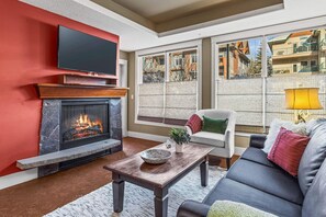 TV, fireplace - Solara Escape – 2BR | Pool • Hot Tub • Gym. Spa (Canmore)
