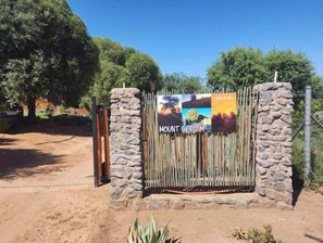 Enter a serene natural haven at Mount Gerizim, where a rustic gate welcomes you to a tranquil retreat.